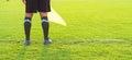 Low section of Soccer assistant referee (Linesman) standing on the edge of field, panoramic view with copy space