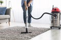 Low section of woman cleaning rug carpet with vacuum cleaner Royalty Free Stock Photo