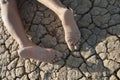 Low section of a woman lying on cracked land