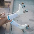 low section woman tying lace roller skate road. High quality photo
