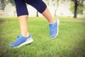 Low section of woman walking on grass Royalty Free Stock Photo