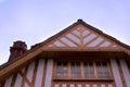 Low to high shot of a building with a sloping roof and wooden fr