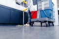 Low shot of cleaning lady mopping the floor in restroom