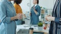 Low shot of group of women talking gesturing then shaking hands coming to agreement in office