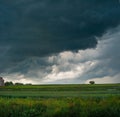 low storm clouds outside the city in the field Royalty Free Stock Photo