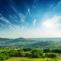 Low sun in blue sky over mountain Royalty Free Stock Photo