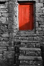 Low sun, on an old red wooden barn door. Monochrome style. Muker, Swaledale, North Yorkshire. England. Royalty Free Stock Photo