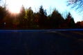 low sun in the trees behind the country road across the Hohe Acht Royalty Free Stock Photo