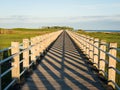 Boardwalk, perspective with vanishing point leading lines and shadow pattern Royalty Free Stock Photo