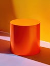 Bright tangerine cylinder pedestal against warm gradient, energetic color blocking with bold modern Royalty Free Stock Photo
