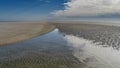 Low tide on the ocean. The seabed with undulating sandy ridges is exposed.