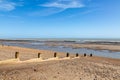 Low tide at Pett Level beach on the Sussex coast, with a blue sky overhead Royalty Free Stock Photo