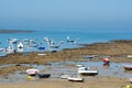 Low tide time on ocean coast of Cadiz, shallow water with fishing boats and seagulls, Andalusia, Spain Royalty Free Stock Photo