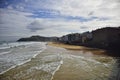 low tide on a wide city beach. On the Way of St. James