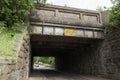 Low UK railroad / railway bridge with warning