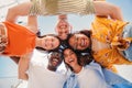 low view angle of a group of multiracial teenagers smiling and looking at camera together. Portrait of five young Royalty Free Stock Photo