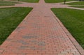 Low view of brick paths going off in eight different directions surrounded by thick grass, so many choices, horizontal aspect Royalty Free Stock Photo