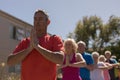 Group of senior people performing yoga in the park Royalty Free Stock Photo