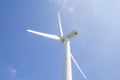 Low angle view of wind turbine against partly cloudy blue sky Royalty Free Stock Photo