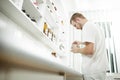 Low view of young pharmacist preparing medicine