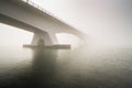 Low visibility due to heavy fog covering the Zeeland bridge, sun Royalty Free Stock Photo