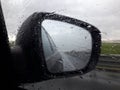 Water drops on the window affect the visibility in the rear mirror. Royalty Free Stock Photo