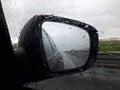 Rear view mirror reflecting road and sky Royalty Free Stock Photo