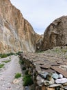 Low wall of ancient engraved stones in the Valley of Markah in Ladakh, India. Royalty Free Stock Photo