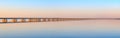 Low water bridge from Sedanka to the De Friz peninsula across the Amur Bay of Primorsky Krai Russia against the background of a
