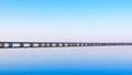 Low water bridge from Sedanka to the De Friz peninsula across the Amur Bay of Primorsky Krai Russia against the background of a Royalty Free Stock Photo