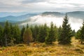 Low white clouds below the mountain tops