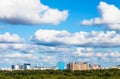 Low white clouds in blue sky over city in summer Royalty Free Stock Photo