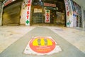 Low wideangle shot of floor markings for social distancing in front of a closed chemist shop as the new wave of