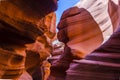 Lower Antelope Canyon`s Wave-curved rock maze with changing light and shadow.