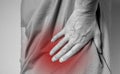 Lower back pain. Lumbago. Man hands holding red painful point closeup. Spinal injury, pinched muscles. Health problems Royalty Free Stock Photo