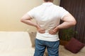 Lower back pain. Man in white shirt holding his back in pain Royalty Free Stock Photo