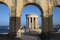 LOWER BARRAKKA GARDENS, VALLETTA, MALTA - NOVEMBER 16TH 2019: The Siege Bell War memorial seen through an archway. Built in 1992 Royalty Free Stock Photo