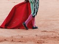 Legs, muleta and sword of a matador