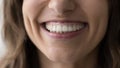 Lower face part and toothy smile of young woman, closeup