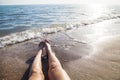Lower half of the girl body lying on the beach by the sea Royalty Free Stock Photo