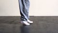 Lower half of sporty dancers feet moving