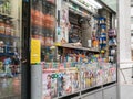 Lower Manhattan news cart proprietor peers out from cart window