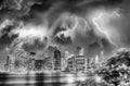 Lower Manhattan night skyline with storm approaching. East River Downtown skyscrapers lights reflections, New York City - USA Royalty Free Stock Photo