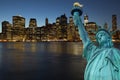 Lower Manhattan at night with Statue of LIberty Royalty Free Stock Photo