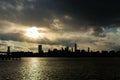 Lower Manhattan Skyline on the East River in New York City during Sunset with Skyscraper Silhouettes Royalty Free Stock Photo