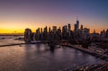 Lower Manhattan skyscrapers silhouettes against colourful sunset sky. Heavy traffic on roads along water. Manhattan, New Royalty Free Stock Photo