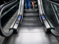 Lower Section of People Using Escalator at the Shopping Mall