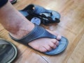 Lower Section of Woman Fitting Rubber Sandals at Store