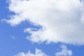 Lowering clouds in blue summer sky .