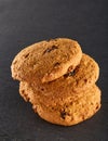 Lowkey picture of stack of chocolate chip cookies on dark stony background, close-up, shallow depth of field Royalty Free Stock Photo